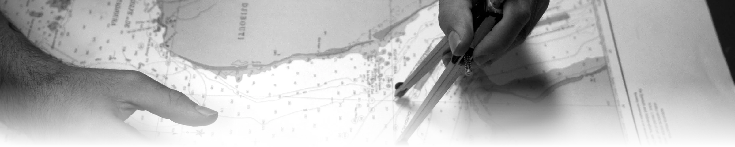 A sailor using navigational dividers to plot a precise fix on a paper nautical chart